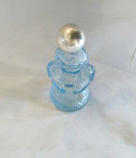 An Empty Avon Collectible Blue Glass Angel Bottle With A Gold Plastic Screwed On Lid. C 76