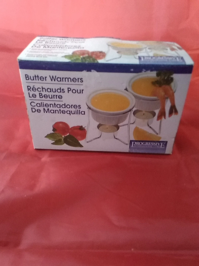 Boxed Set Of Progressive International Corp Butter Warmers, Never Used. It Includes 2 Stands, Ceramic Dishes & Candles. Dish 760