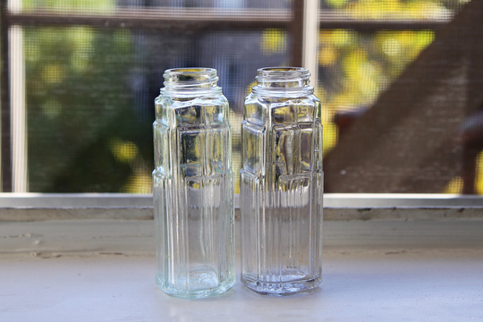 Pair Of Antique Clear Glass Art Deco Bottles, Found in New York Usa, Two Apothecary Raised Embossed Design