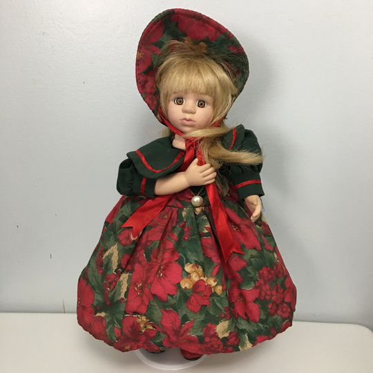 Adorable 12" Tall Musical Porcelain Doll That Is Dresses in Holiday Clothes Which Plays " We Wish You A Merry Chirstmas